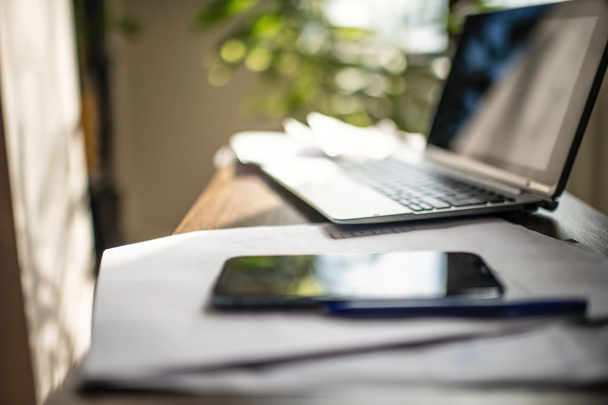 Laptop and financial documents on a desk